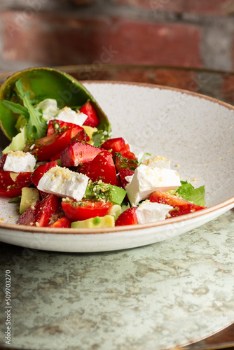 Obraz na płótnie Tasty and healthy salad with arugula, brie cheese, avocado, cherry tomatoes and strawberry. Top view. The flat lay. Banner w salonie