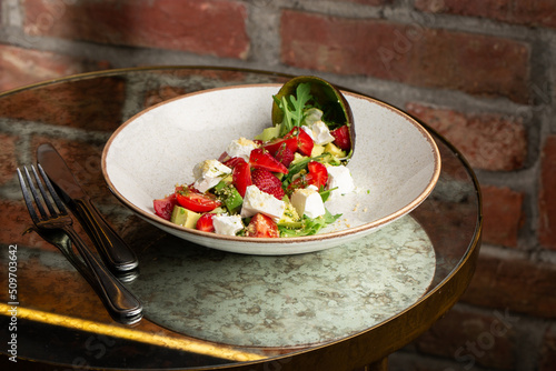 Obraz na płótnie Tasty and healthy salad with arugula, brie cheese, avocado, cherry tomatoes and strawberry. Top view. The flat lay. Banner w salonie