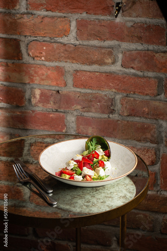 Obraz na płótnie Tasty and healthy salad with arugula, brie cheese, avocado, cherry tomatoes and strawberry. Top view. The flat lay. Banner w salonie