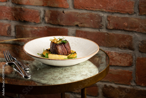 Obraz na płótnie Grilled meat fillet steak medallion with green sauce, served with pear or apple. On dark background w salonie