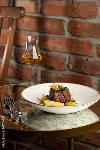 Obraz na płótnie Grilled meat fillet steak medallion with green sauce, served with pear or apple. On dark background w salonie