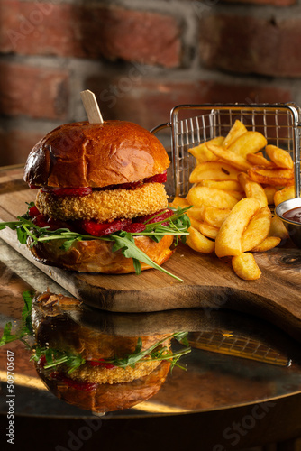 Obraz na płótnie Big cheeseburger with french fries. Hamburger with beef patty onion, tomato, lettuce pickles, melted cheddar, mustards, tomato jam, mayo w salonie