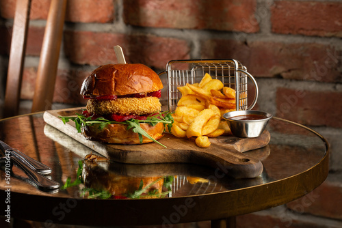 Obraz na płótnie Big cheeseburger with french fries. Hamburger with beef patty onion, tomato, lettuce pickles, melted cheddar, mustards, tomato jam, mayo w salonie
