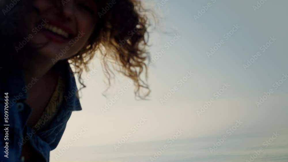 Happy girl posing at camera on beach. Portrait of smiling woman face Happy girl posing at camera on beach. Portrait of smiling woman face