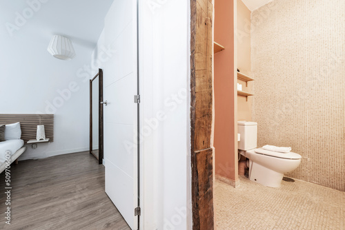 Vacation rental apartment with renovated bathroom with vintage wooden beams, double bed and wall mirror