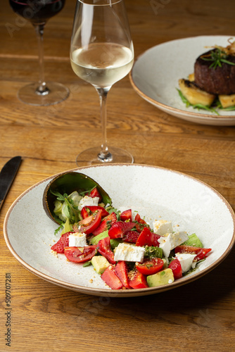 Obraz na płótnie Tasty and healthy salad with arugula, brie cheese, avocado, cherry tomatoes and strawberry. Top view. The flat lay. Banner w salonie
