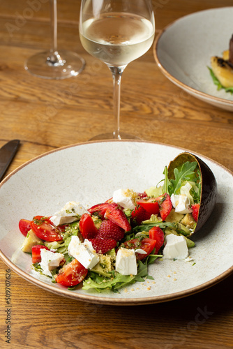 Obraz na płótnie Tasty and healthy salad with arugula, brie cheese, avocado, cherry tomatoes and strawberry. Top view. The flat lay. Banner w salonie