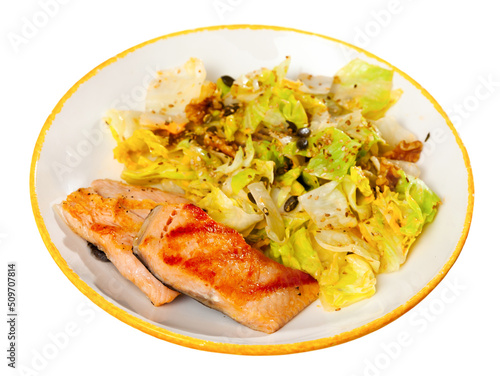 Grilled salmon steak with fresh lettuce salad. Isolated on white background