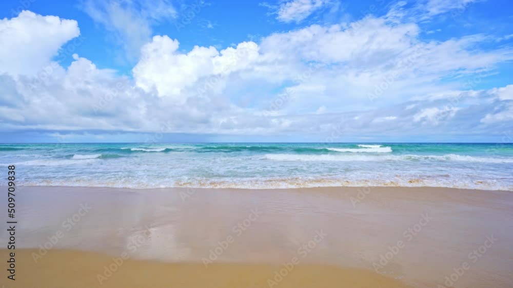 Tropical ocean at daytime in Phuket Thailand Beautiful sea in summer season. Waves crashing on sandy shore Summer season greeting background Tropical ocean at daytime in Phuket Thailand Beautiful sea in summer season. Waves crashing on sandy shore Summer season greeting background