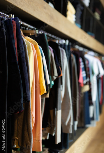 Variety of men clothes in modern garments shop