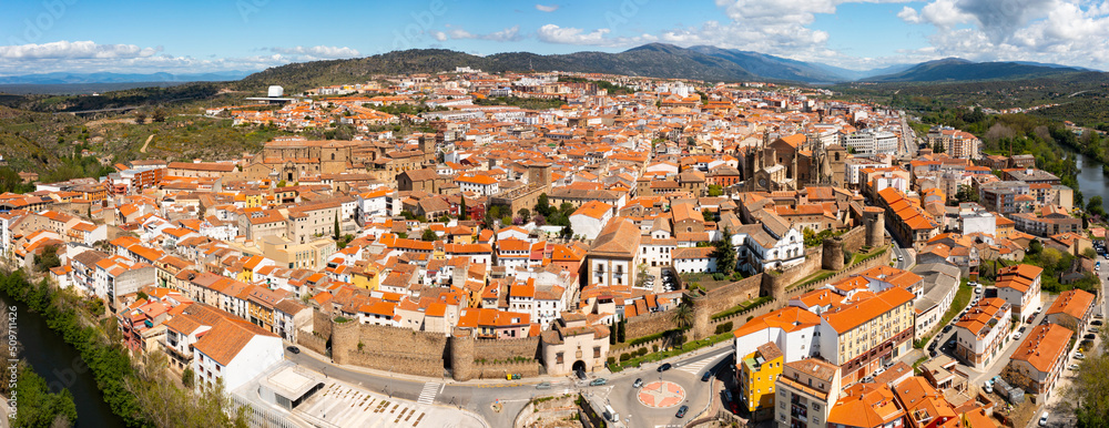 Scenic panoramic view from drone of ancient walled Spanish city of Plasencia on bank 