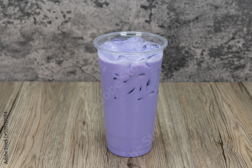Tasty taro milktea in a tall cup and ice cold for that thirsty appetite photo