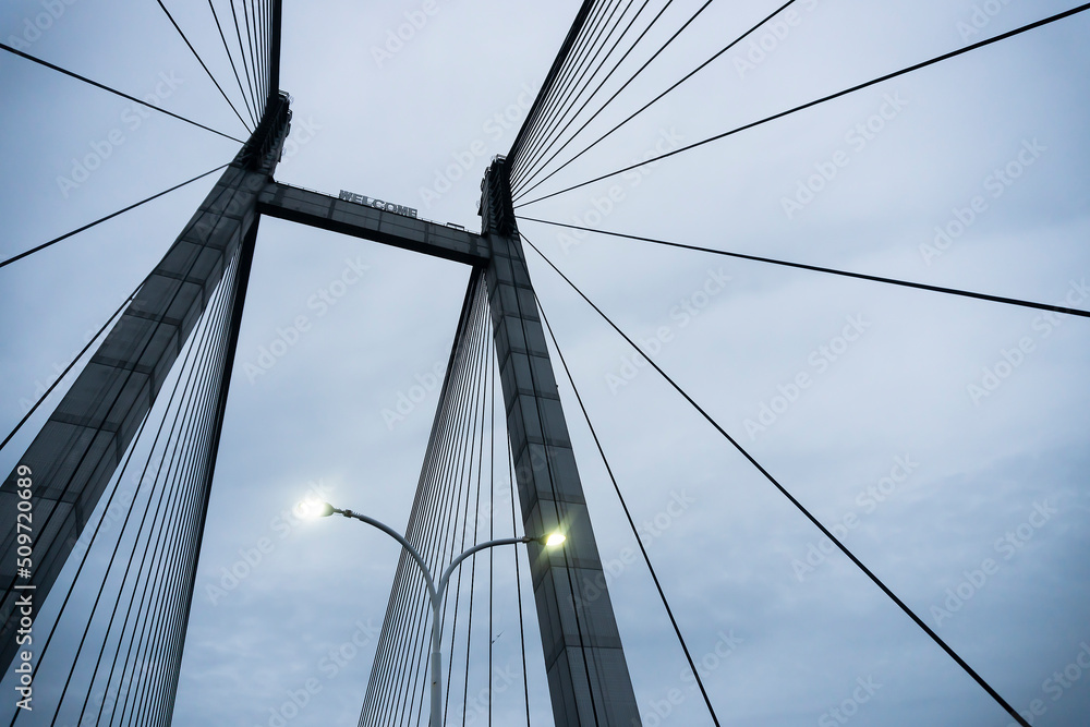 Fototapeta premium Cables of 2nd Hoogly bridge, vidyasagar setu at blue hour. Monsoon stock image.