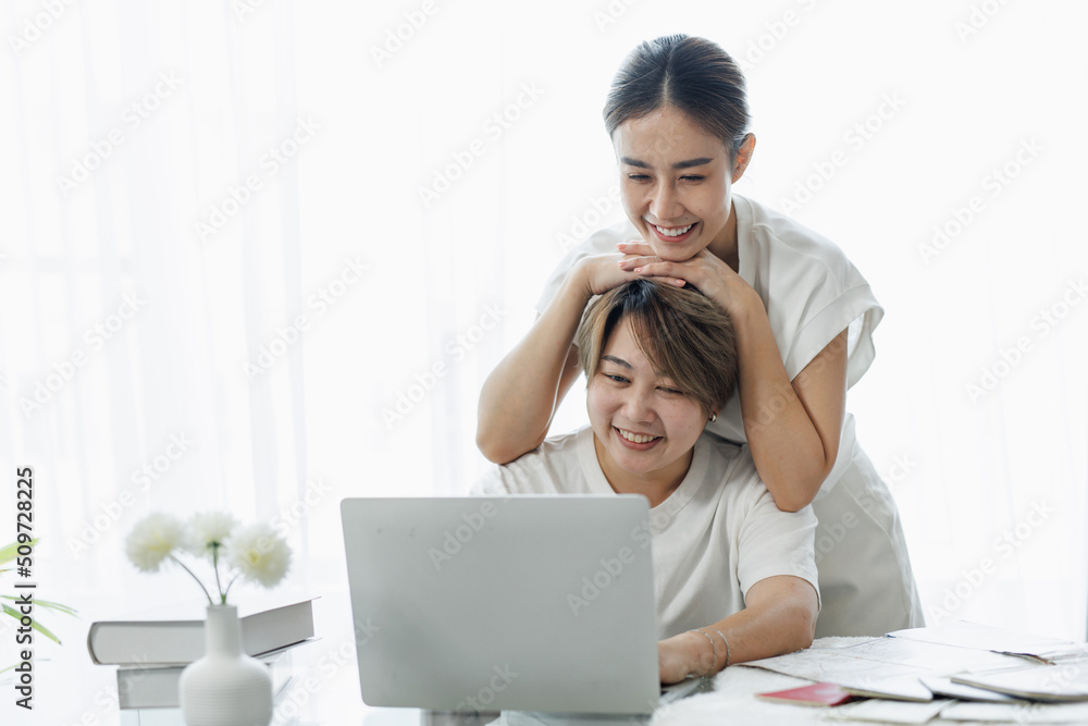 Happy lgbt gay couple of Asian women having fun using a computer laptop at home - LGBT lesbian relationship, Asian LGBTQ female lesbian concept. Happy lgbt gay couple of Asian women having fun using a computer laptop at home - LGBT lesbian relationship, Asian LGBTQ female lesbian concept.