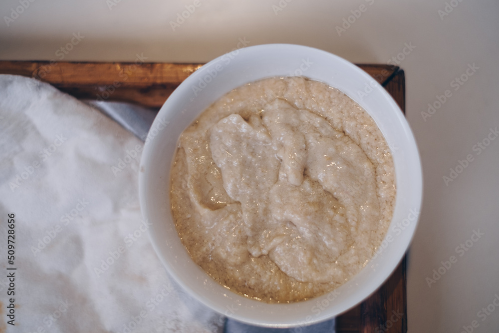 Close up of the popular Pita bread and hummus in white bowl in wooden tray. Flat lay. Selective focus. Close up of the popular Pita bread and hummus in white bowl in wooden tray. Flat lay. Selective focus.