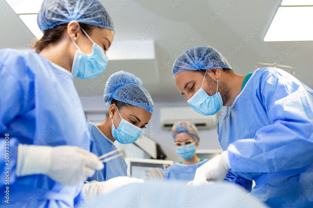 Urgent surgery. Professional smart intelligent surgeons standing near
