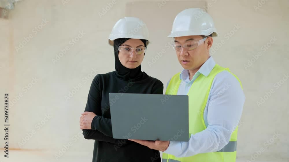 Arab Muslim investment buying real estate in China. Cooperation of two multinational investors. Asian Industry Engineer Showing Project on Laptop Talking with Arab Muslim Investor Discussing Agreement Arab Muslim investment buying real estate in China. Cooperation of two multinational investors. Asian Industry Engineer Showing Project on Laptop Talking with Arab Muslim Investor Discussing Agreement