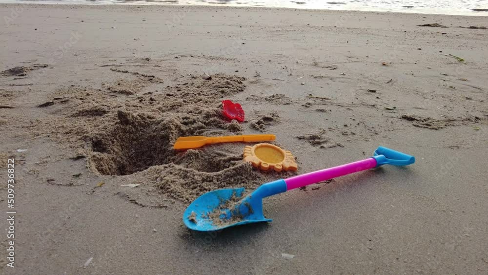 Slowly move toward shovel and beach toy. Summer outdoor activity Slowly move toward shovel and beach toy. Summer outdoor activity