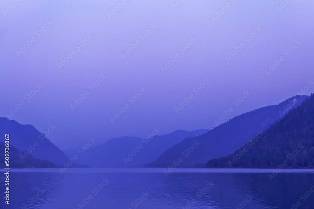 Lake Teletskoye, Altai Republic, Russia. Blue clear sky and Mirror of lake. Abstract panoramic landscape with natural gradient blue color, nature environment scene, monochrome background