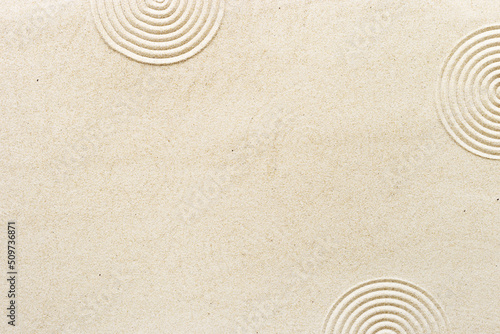 Circle lines on sand, beautiful sandy texture. Natural sand background for spa wellness, concept for relaxation balance and harmony. Concentration and spirituality in Japanese zen garden