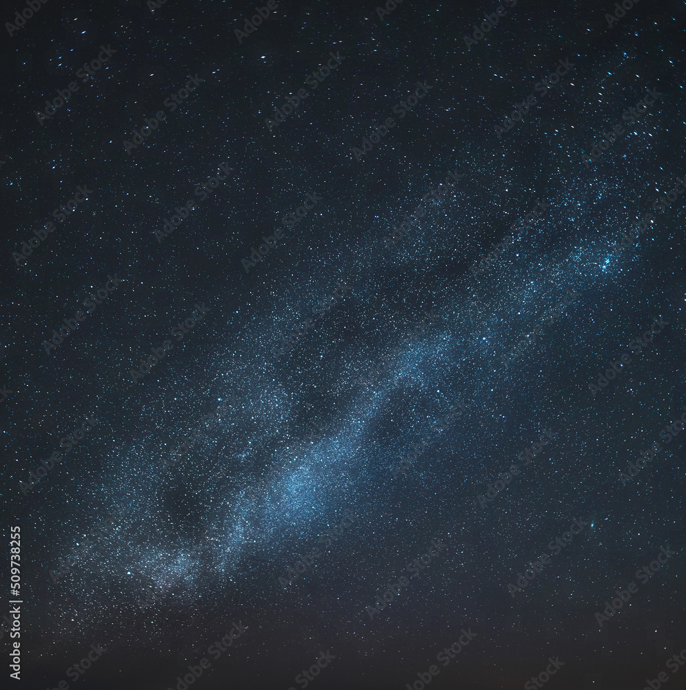 Night skyscape of a starry sky at the seashore. Stars constellations and Milky Way galaxies in the night sky. Concept of dreaming and stargazing.