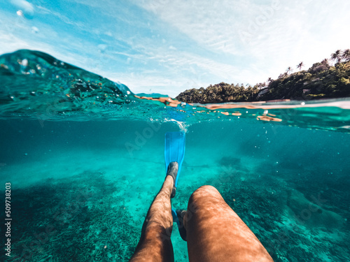 Fotografie, Obraz Snorkeling in the sea on a tropical island