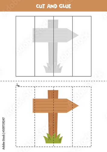 Cut and glue parts of wooden direction sign.