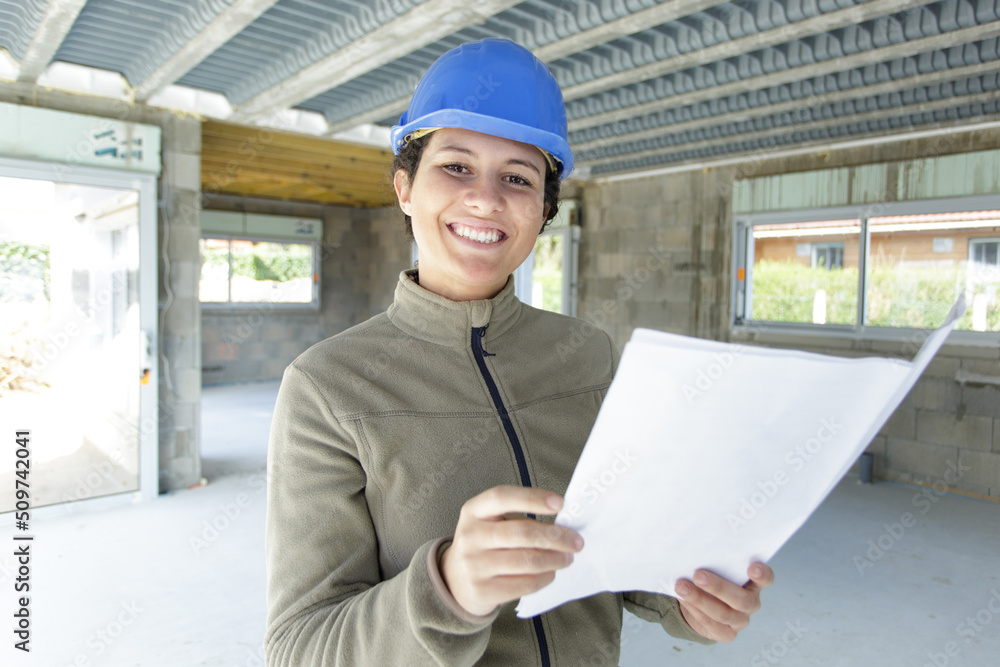 woman on building site holding paperwork woman on building site holding paperwork