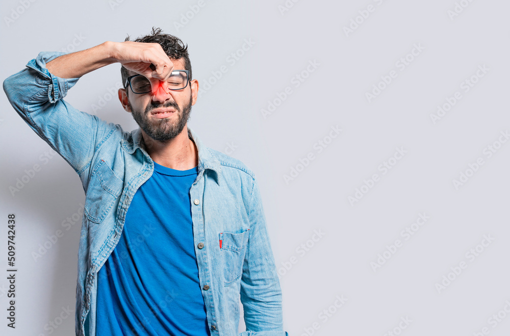 A person with nasal bridge pain. Man with nasal bridge headache, person with pain touching nose. sinus pain concept A person with nasal bridge pain. Man with nasal bridge headache, person with pain touching nose. sinus pain concept