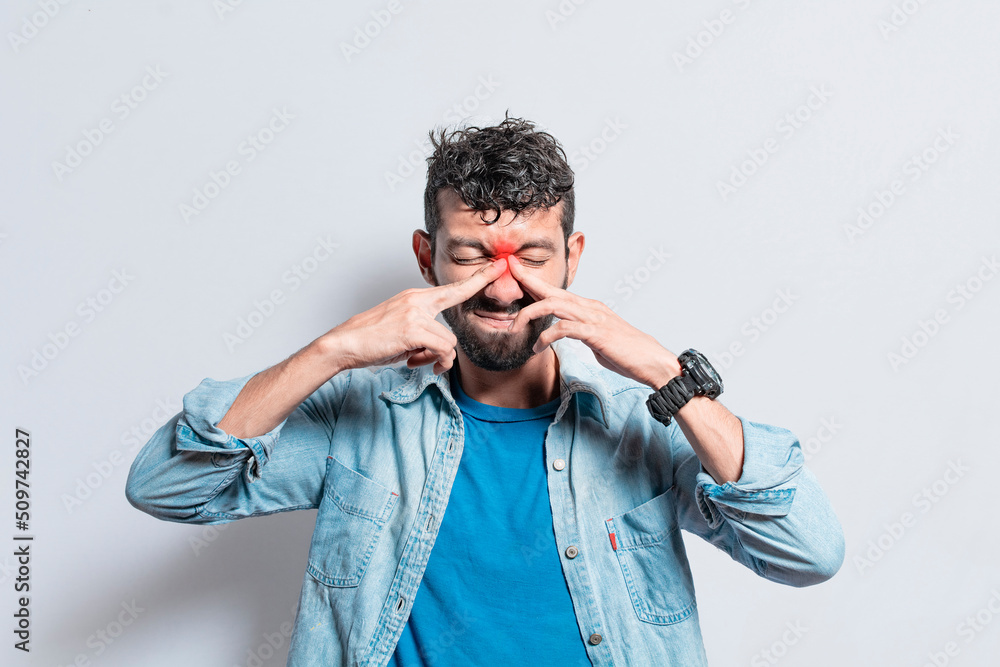 Man with nasal bridge headache, person with pain touching nose. sinus pain concept, A person with nasal bridge pain Man with nasal bridge headache, person with pain touching nose. sinus pain concept, A person with nasal bridge pain