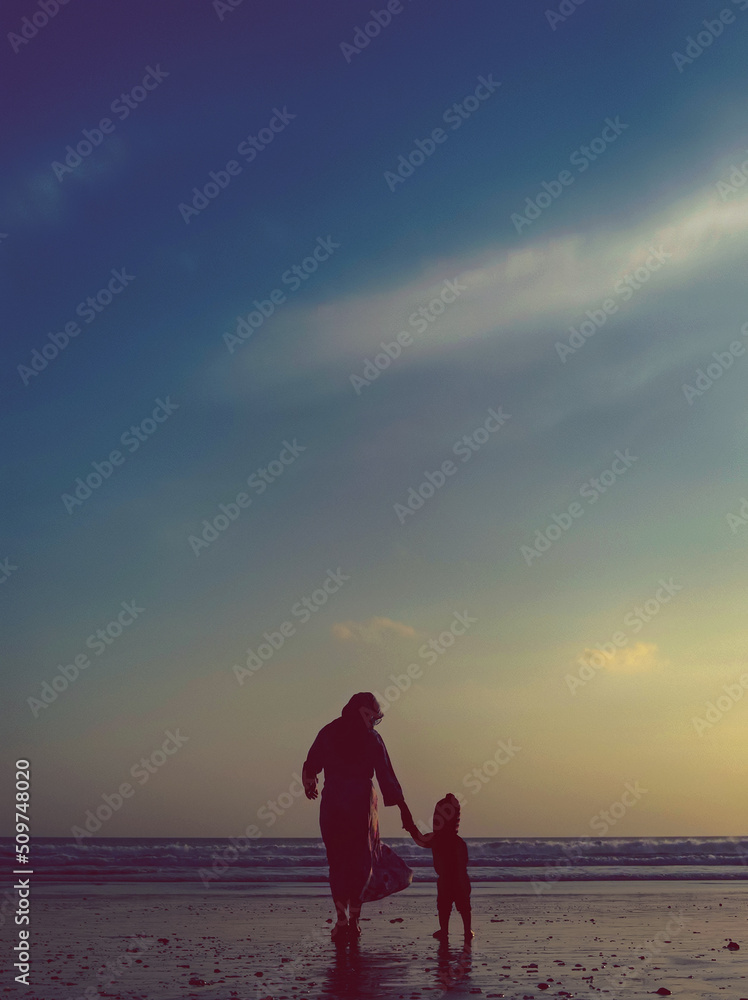 parent and child at sunset