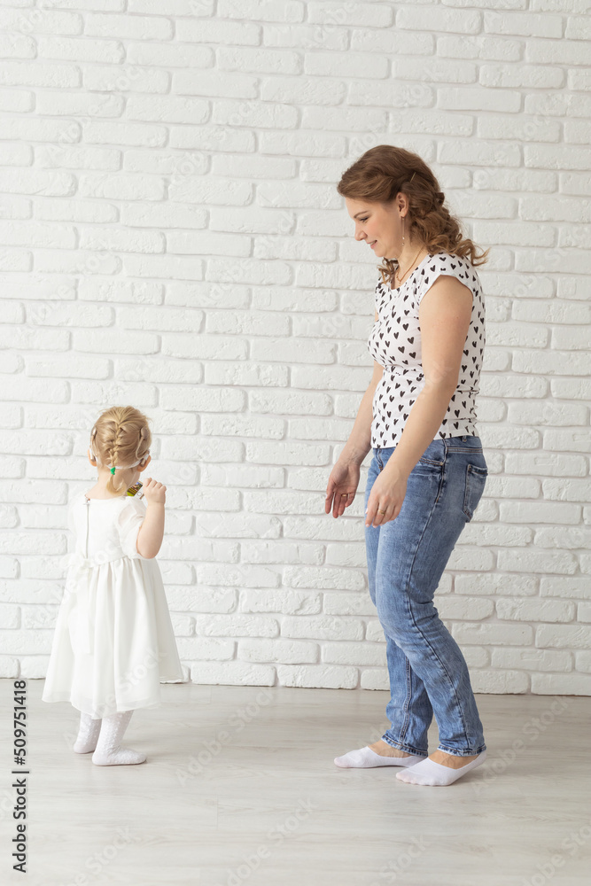 Child with cochlear implant hearing aid having fun with mother - diversity and deafness treatment and medical innovative technologies Child with cochlear implant hearing aid having fun with mother - diversity and deafness treatment and medical innovative technologies