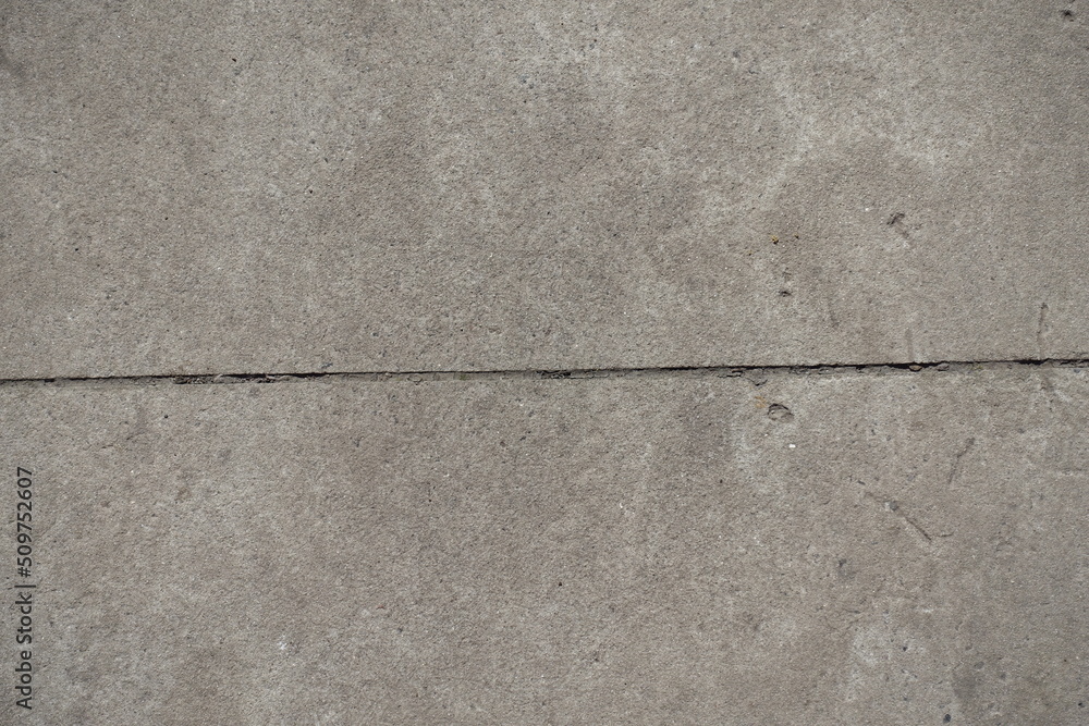 Fototapeta premium Horizontal joint between two simple gray concrete slabs