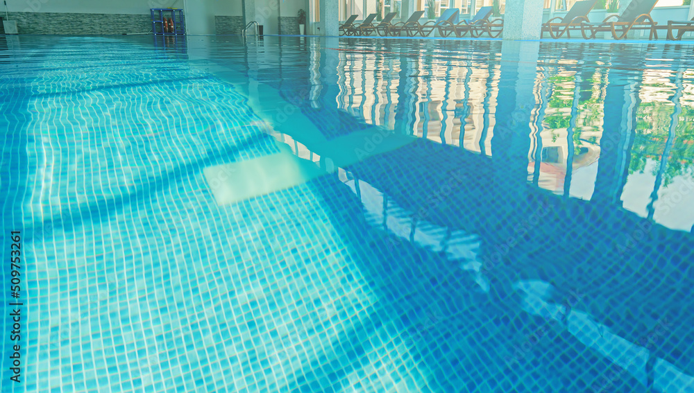 Water surface in an empty hotel swimming pool.
