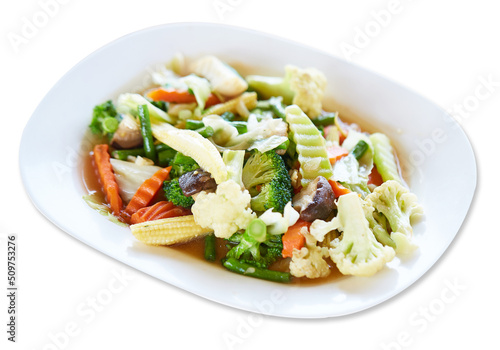 Stir Fried Mixed Vegetable (Sliced baby corn, oringi, shiitake, carrots, kale, cauliflower, cauliflower and yard long beans) are served with white plate isolated on white background. good healthy food
