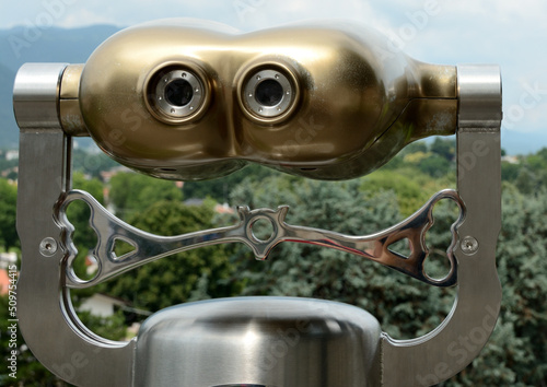 coin operated binoculars on the background of the city