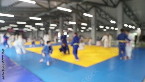 teenagers in kimono doing judo warm-up blurred focus