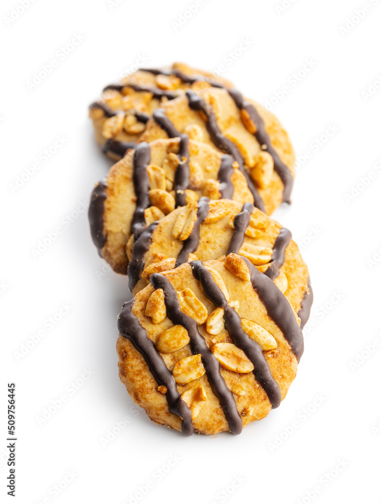 Chip cookies with peanuts and chocolate strips isolated on white background.