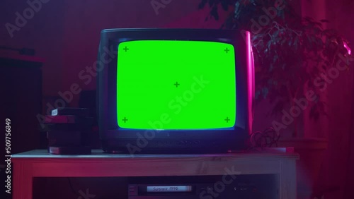 Close Up Footage of a Dated TV Set with Green Screen Mock Up Chroma Key Template Display. Nostalgic Retro Nineties Technology Concept. photo