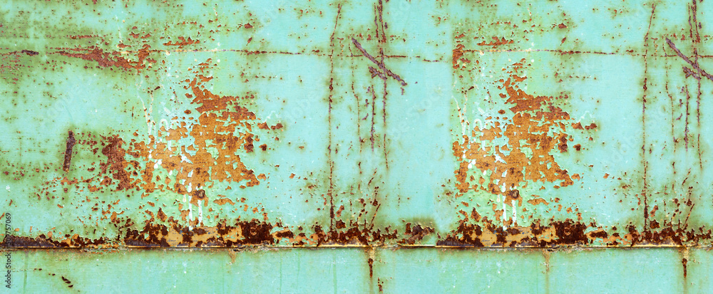 Texture of green painted metallic wall cracked and rusty from time, vintage.