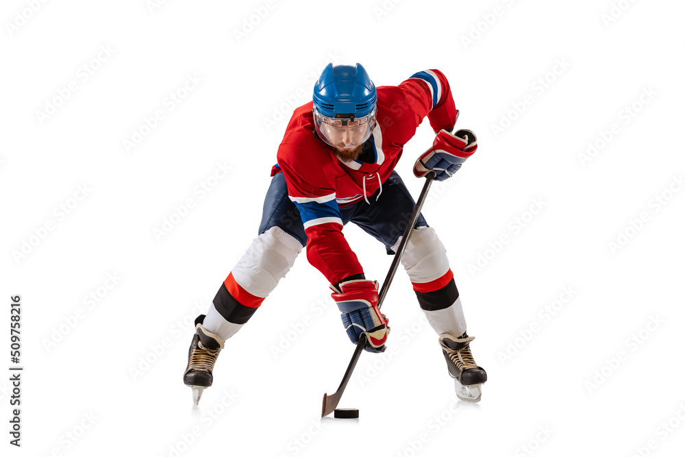Young male hockey player in sports uniform and protective equipment training isolated on white background. Concept of sport, healthy lifestyle, motion, movement, action.