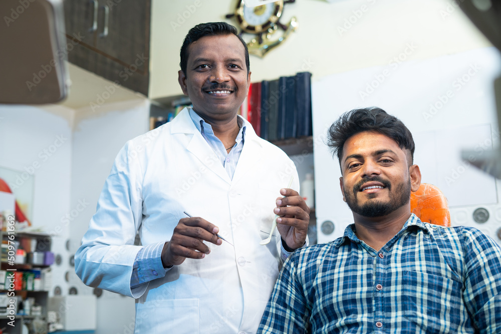 Portrait shot of happy smiling patient with dental doctor or dentist at hosptial looking at camera - concept of oral care, diagnosis and treatment Portrait shot of happy smiling patient with dental doctor or dentist at hosptial looking at camera - concept of oral care, diagnosis and treatment