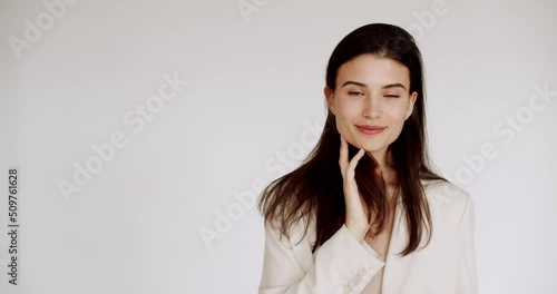 Beauty woman smiling with face healthy clean fresh skin beauty female model on white isolated wall. The concept of perfect young skin and beauty. Beauty video concept, close up portrait. Happy woman. photo