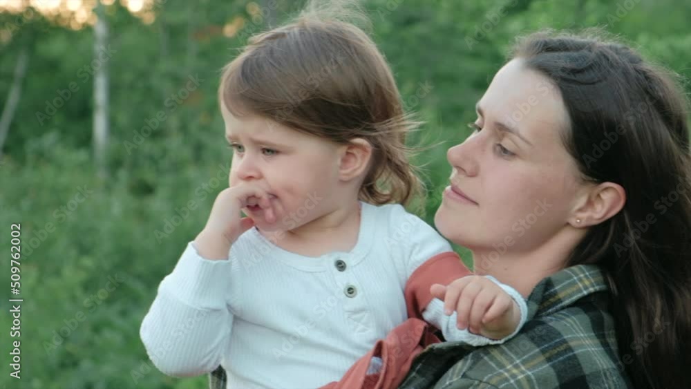 Close up portrait of caring loving young mother holding pretty little daughter child enjoying summer nature during sunset or sunrise. Happy family concept. Cute kid girl in park with beautiful mom Close up portrait of caring loving young mother holding pretty little daughter child enjoying summer nature during sunset or sunrise. Happy family concept. Cute kid girl in park with beautiful mom