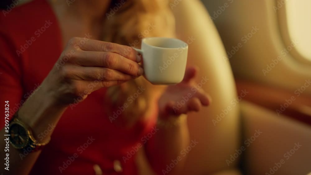 Closeup blonde drinking coffee on airplane trip closeup. Elegant lady enjoying Closeup blonde drinking coffee on airplane trip closeup. Elegant lady enjoying