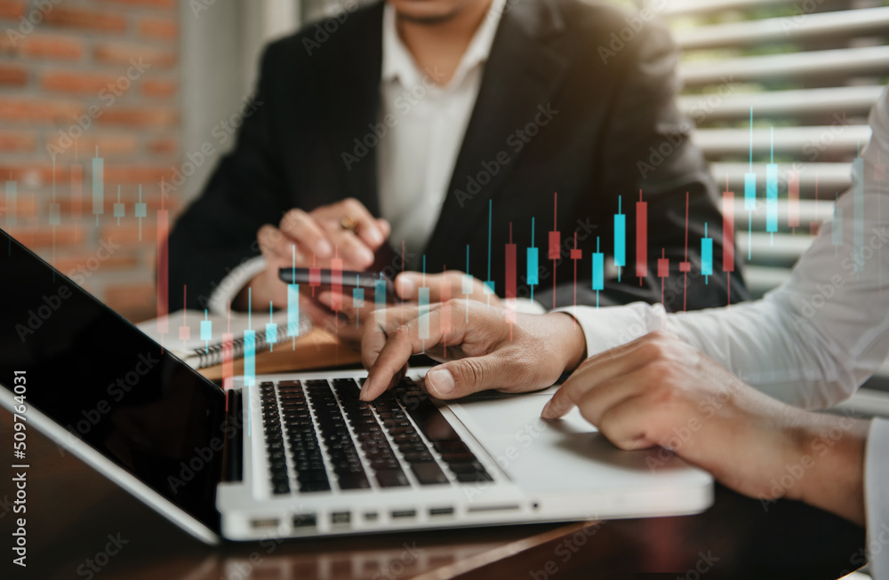 Businessmen trading stocks online. Stock brokers looking at graphs, indexes and numbers on tablet and laptop. Business success concept. Businessmen trading stocks online. Stock brokers looking at graphs, indexes and numbers on tablet and laptop. Business success concept.