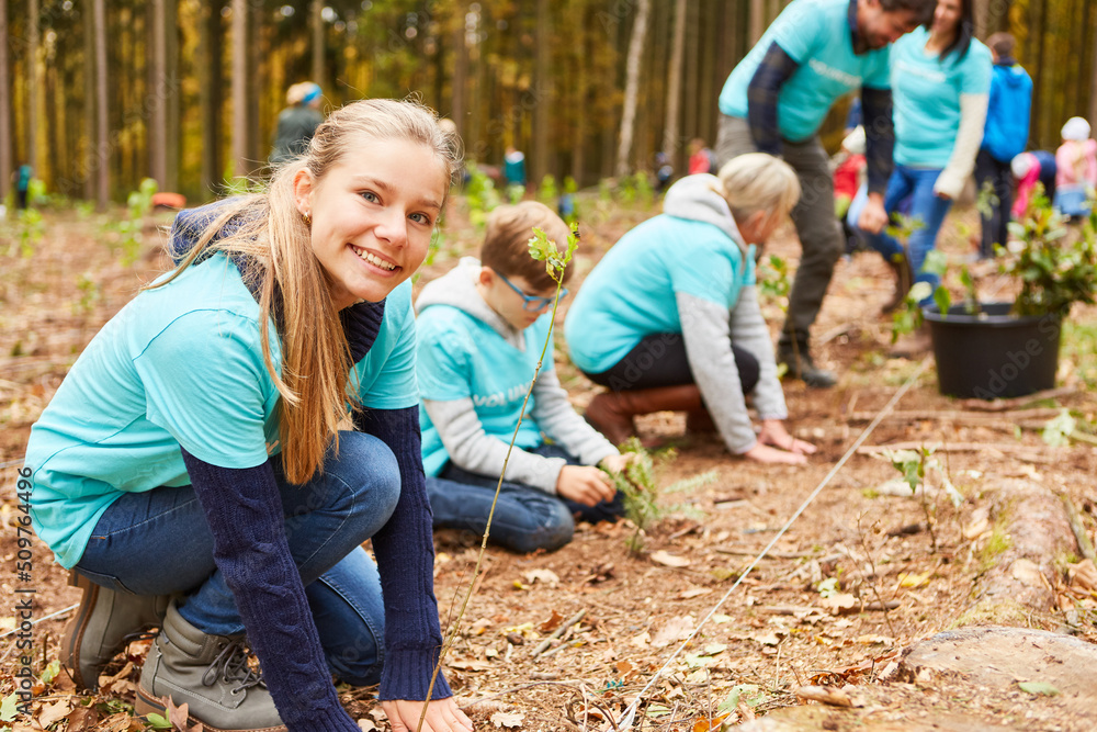 Kinder und Familie als Freiwillige beim Baum pflanzen