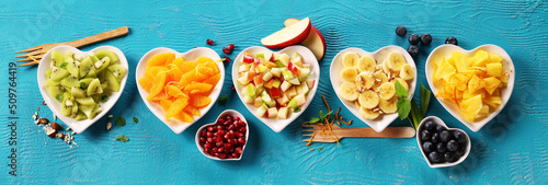 Various fruits on turquoise background.