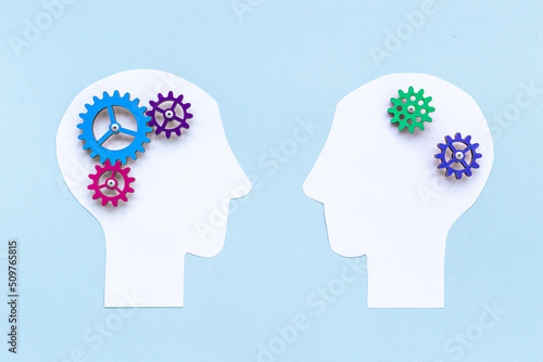 Brain work - gears on two paper human heads. Teamwork concept