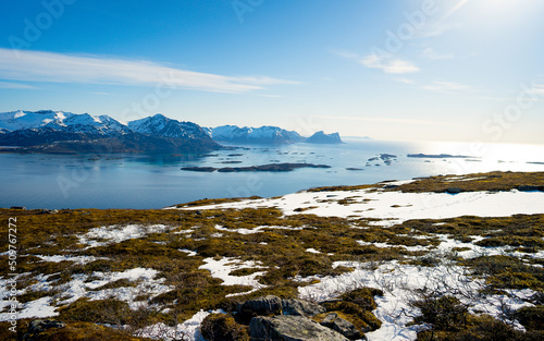 Norwegian nortern fjords, Ersfjorden and Bergsfjorden, and small town tucked away among hills. Viewpoint from Husfjellet, Senja island. Tourism, travel concept.